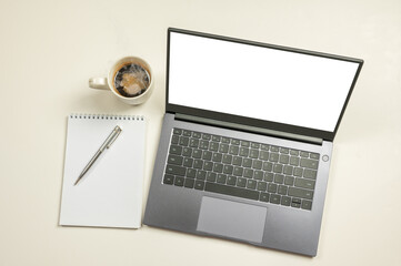 Poster - mockup computer laptop with white blank screen, notepad, coffee cup and copy space on white background.