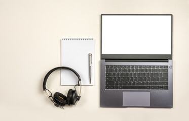 Poster - Minimal workplace mockup with laptop, blank notepad and headphones, on white isolated background. laptop with blank screen , mock up computer for apply screen display on web and app isolated on white