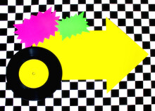 Photograph Of 45rpm Record With Colorful Shapes On Checkered Floor