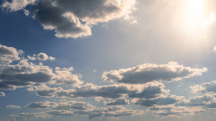 Wall Mural - Wonderful view of cumulus clouds sky with sun light. Daylight yellow sunshine