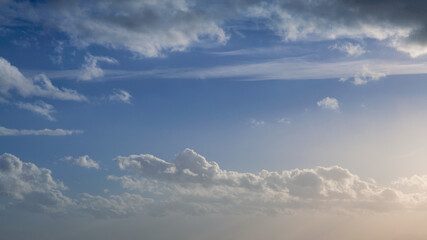 Wall Mural - Wonderful view of cumulus clouds sky with sun light. Daylight yellow sunshine