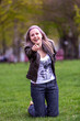 © Denys - Young blonde with blue eyes in the park on green grass flirts with the camera