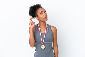 Sticker - Young African American woman with medals isolated on white background with fingers crossing and wishing the best