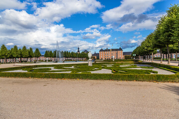 Wall Mural - Schwetzingen, Germany. Fountain and flower bed in the central alley of the park