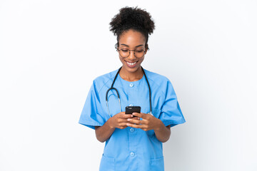 Young surgeon African American doctor woman isolated on white background sending a message with the mobile