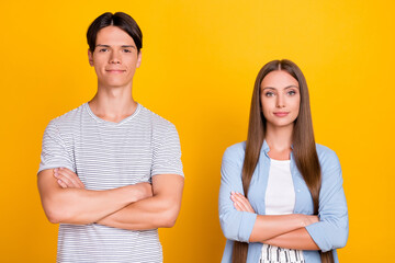 Sticker - Portrait of attractive content cheery couple partners coworkers folded arms isolated over bright yellow color background