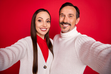 Poster - Photo of cheerful happy man and woman hold camera make selfie enjoy cool isolated on red color background