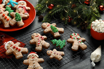 Wall Mural - Making homemade Christmas cookies. Gingerbread people and festive decor on black table