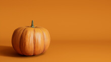 Pumpkin On A Orange Colored Background. Fall Themed Wallpaper With Copy-space.
