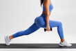 © nikolas_jkd - Fitness woman doing lunges exercises for leg muscle training. Active girl doing front forward one leg step lunge exercise