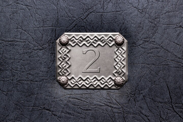 silver frame on door, wall with number 2, second place concept