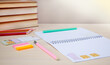 © Scarlett forest - Pen, notepad,books and pencil on the table. Completing school homework