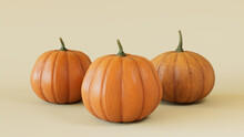 Three Pumpkins On A Cream Colored Background. Autumn Themed Wallpaper.