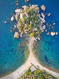 Fototapeta  - Isola Bella small island near Taormina, Sicily, southern Italy. Narrow path connects Isola Bella island to mainland Taormina beach surrounded by azure waters of the Ionian Sea.
