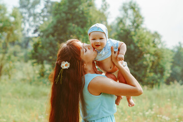 mother raises the child in her arms