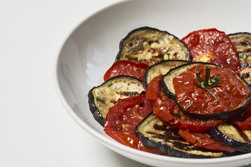 Sticker - Delicious dish made of eggplant with tomatoes on a plate