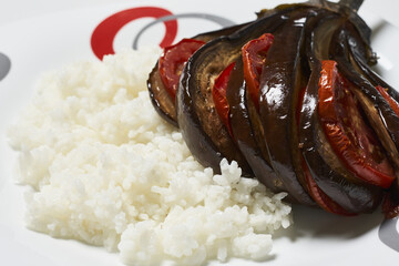 Poster - Delicious dish made of eggplant with tomatoes and rice on a plate