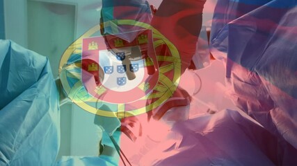 Sticker - Animation of flag of portugal waving over surgeons in operating theatre