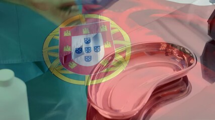 Sticker - Animation of flag of portugal waving over surgeons in operating theatre