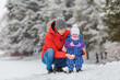 © bearmoney - Smiling little girl having fun with father in winter park. Cute two year old kid with parent playing snowballs maker toy. Concept of happy family and childhood, togetherness, care, winter games