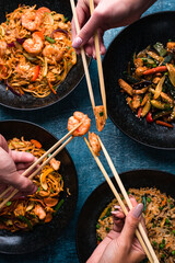 Poster - hand with chopsticks, eating asian food, top view. Chinese and vietnamese cuisine set.