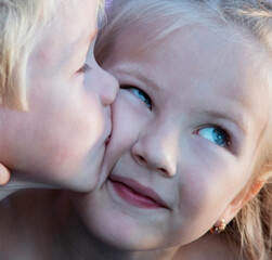 Love concept. Couple of kids loving each other hugging and kissing. Little boy kissed a sister