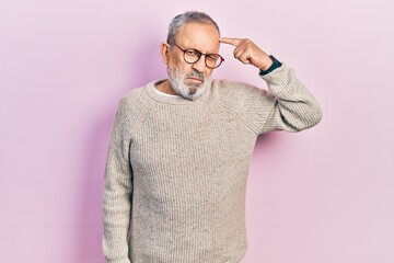 Wall Mural - Handsome senior man with beard wearing casual sweater and glasses pointing unhappy to pimple on forehead, ugly infection of blackhead. acne and skin problem