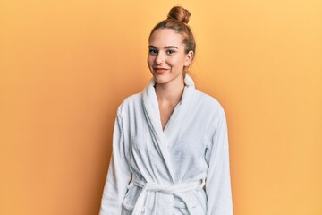 Wall Mural - Young blonde woman wearing bathrobe with a happy and cool smile on face. lucky person.