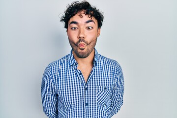 Poster - Young hispanic man wearing casual clothes making fish face with lips, crazy and comical gesture. funny expression.