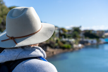 Sticker - woman with hat on looking out at the ocean