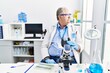 © Krakenimages.com - Senior caucasian man working at scientist laboratory looking to side, relax profile pose with natural face and confident smile.