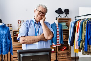 Sticker - Senior man with grey hair working as manager at retail boutique thinking looking tired and bored with depression problems with crossed arms.