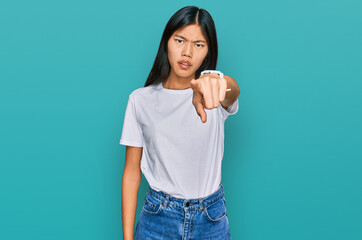 Poster - Beautiful young asian woman wearing casual white t shirt pointing displeased and frustrated to the camera, angry and furious with you