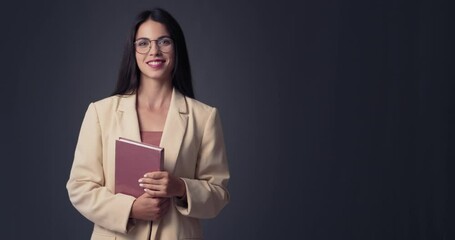 Wall Mural - Beautiful young businesswoman on dark background