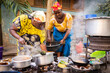 © Jasmin Merdan - African woman cooking traditional food at street