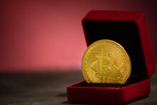 Bitcoin Coin In Small Red Wedding Ring Box On Red Background. St. Valentine's Day Gift. Cryptocurrency Investment Concept.