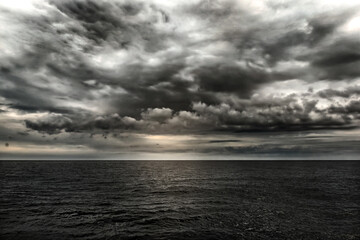 Wall Mural - dark stormy sea with a dramatic cloudy sky