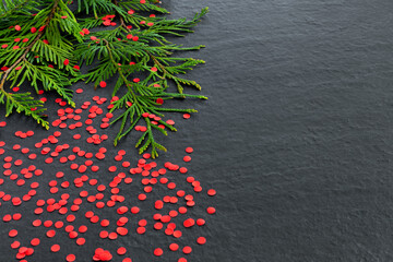 Wall Mural - Toy Christmas white tree with branches spruce and berries on black background. New Year creative greeting card.