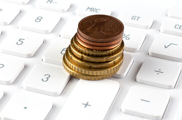 Aufkleber - stack of coins on calculator,concept idea for business finance and education.