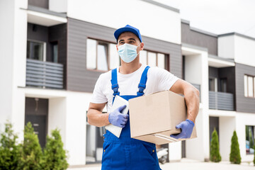 Young courier wearing a protective mask and gloves delivers goods during quarantine