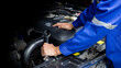 Car mechanic working on car engine, car maintenance concept.
