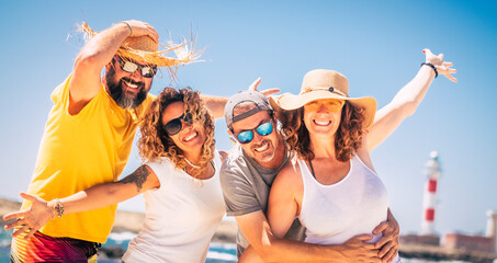 Group of happy people and cheerful adults friends having fun together during summer vacation. Portrait of two caucasian couples posing on holiday tour. Enthusiastic friends posing on vacation