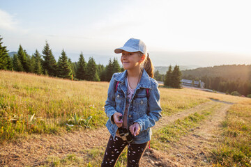 Wall Mural - Happy little girl hiker. Smiling child outdoor portrait.