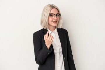 Young caucasian business woman isolated on white background pointing with finger at you as if inviting come closer.