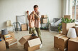 © Seventyfour - Portrait of happy father playing with son in cardboard boxes while family moving to new house, copy space