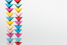 Simple Background With Many Colorful Folded Paper Triangles Arranged In Two Columns