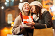 © NDABCREATIVITY - Happy women friends exchanging christmas present. Happiness people friend shopping xmas concept