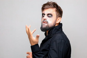 Wall Mural - halloween makeup on a bearded man who gestures at the camera