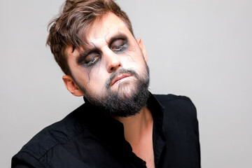 Wall Mural - close-up portrait of a man with a beard with makeup for Halloween in the style of the undead