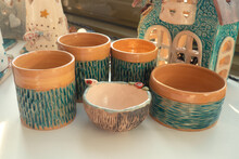 Multi-colored Handmade Ceramic Bowls And Cups Covered With Glaze In The Pottery Workshop